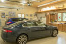 Three stall garage has room to cycle around the Jaguar parked in the middle if the Escape isn't present. Shiny new floor was Linda's idea, pictures on the wall at her instigation too. Proper man-cave complete with beer fridge.